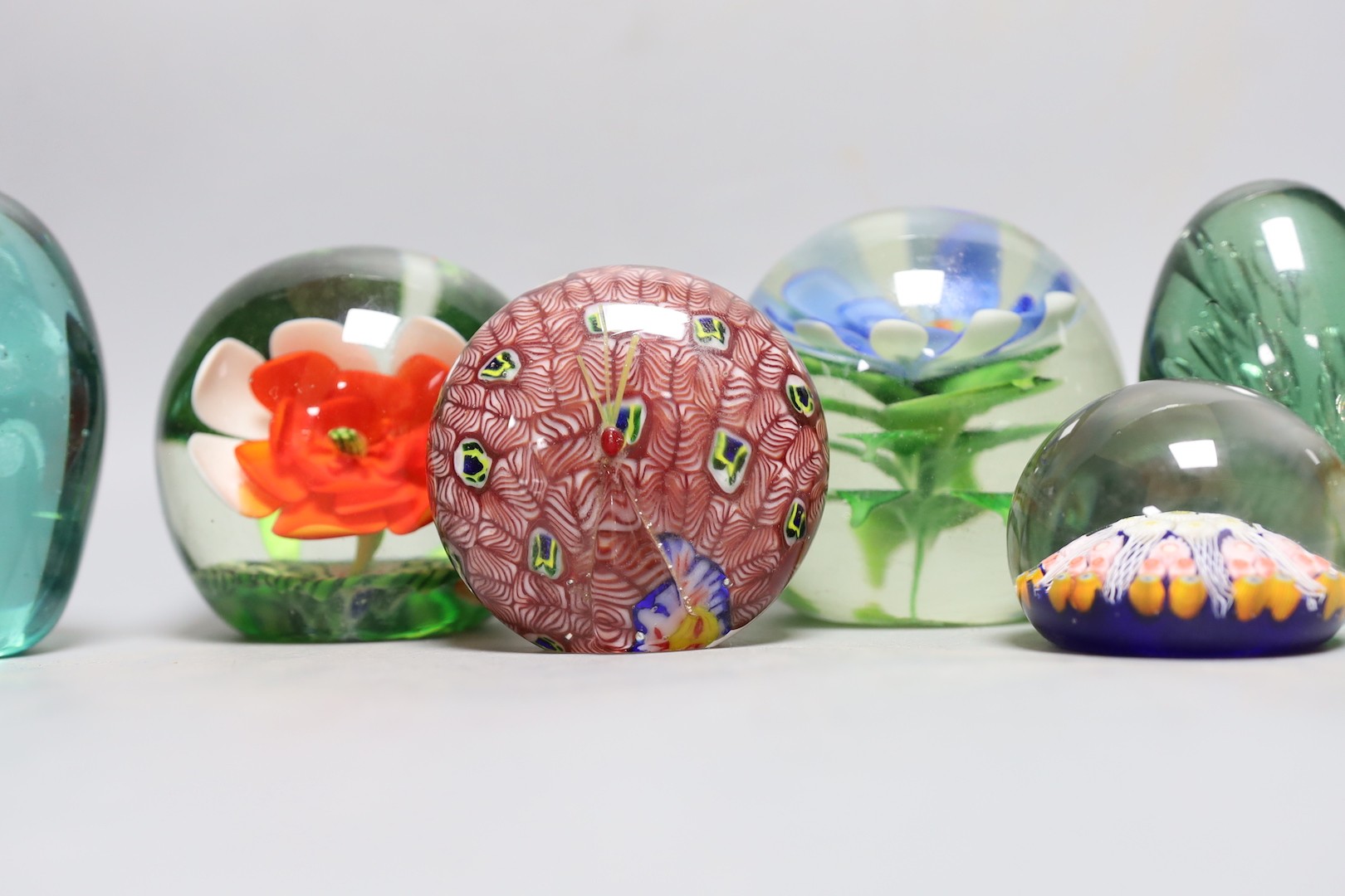 A collection of nine glass paperweights including Victorian dumps and millefiori